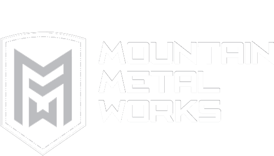 Logo with a shield containing mirrored "M" letters on left, and the text "Mountain Metal Works" on right. White on a grey background.